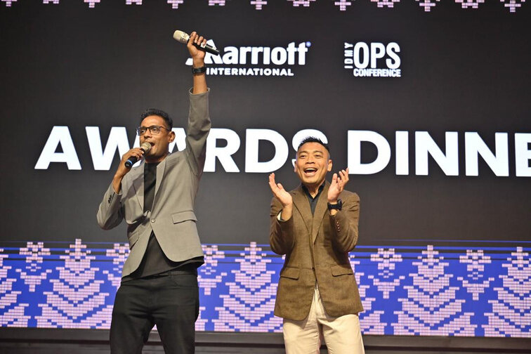 Adam and a guest hosting a Marriott annual dinner
