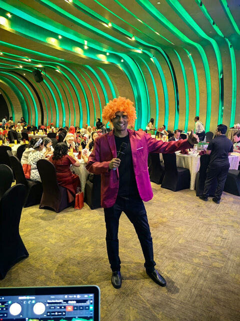 Adam entertaining guests during a dinner