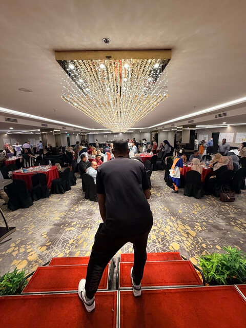 Adam addressing guests from the stage